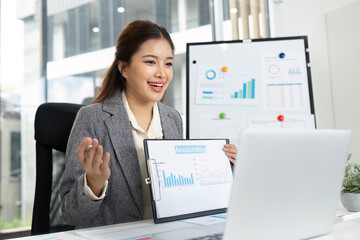 Virtual Meeting and Engagement. Happy businesswoman presenting financial data on video call.