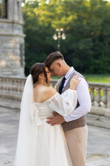Stylish newlyweds dance against the backdrop of green nature and an old castle.Family Union as a...