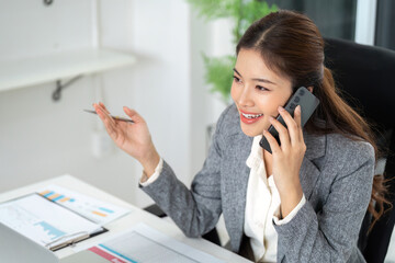 Engaging Phone Conversation in the Office. A businesswoman discusses important matters over the...