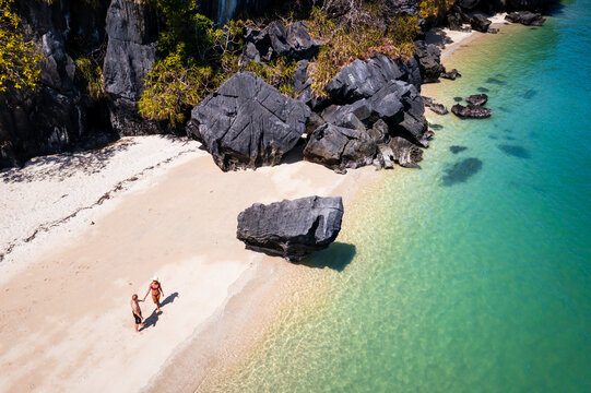 Drone shot of tourist couple at the beach, Langkawi, Malaysia