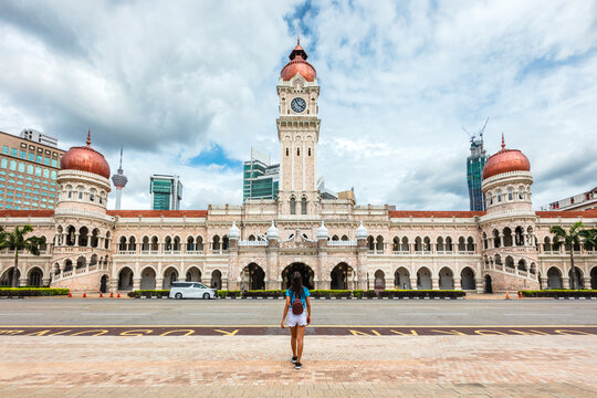 Asian woman standing in front of the Sultan Abdul Samad Building, Kuala Lumpur, Malaysia