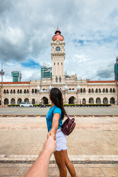 Asian woman holding hand at Merdeka square, Kuala Lumpur, Malaysia