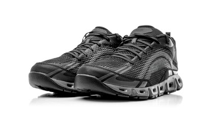 A pair of modern black mesh athletic sneakers isolated on a white background, showcasing a breathable design and cushioned sole for optimal performance and comfort.
