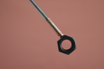 Close up Bendable Flexible Magnetic Pickup black bolt isolate on brown background, Claw Grabber...