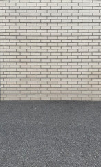 Old brick white wall and asphalt floor