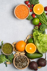 Flat lay of natural plant foods high in folate (vitamin B9) including broccoli, beetroot, oranges, lentils, peanuts, green peas and leafy greens.