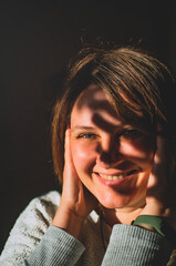Beautiful girl smiling in the sun rays