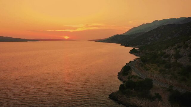 Aerial shot of sunset over the sea with Adriatic coastline in Croatia