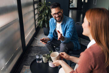 Friendly Conversation Between Two People in a Modern Indoor Setting