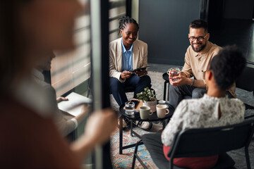 Group of Professionals Engaging in a Casual Discussion During a Break