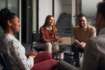 Group of Four People Having a Discussion in a Modern Office