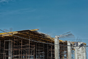 Dangerous collapse of concrete formwork on a construction site. Broken supports, bent rebar, and...