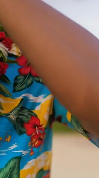 Colorful Hawaiian shirt with lei garland in tropical setting