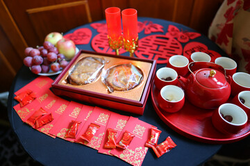Red porcelain tea set on festive table, ideal for Asian traditions, rituals, and celebration themes.
