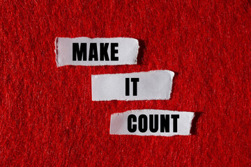 Make it count message written on ripped torn white paper pieces on red background. Conceptual make...