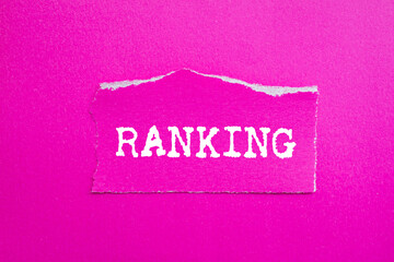 Ranking message written on ripped torn pink paper piece on pink background. Conceptual ranking...