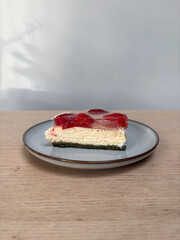 A slice of matcha strawberry cheesecake.