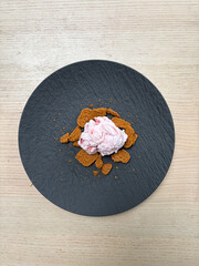 A plate of ice cream with cookies.
