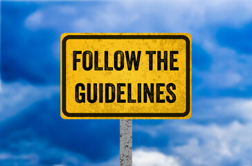 Follow the guidelines message written on yellow metal sign. Conceptual follow the guidelines symbol. Copy space.