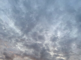 Dramatic clouds. Dark blue clouds swiftly floating across blue sky. Sky texture, abstract nature background. Stormy sky with dark, snowy clouds on a spring day. Clouds are floating across the sky.