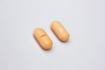 Vitamin C tablets isolated on white background. Vitamin C is a powerful antioxidant that can strengthen your body’s natural defenses.