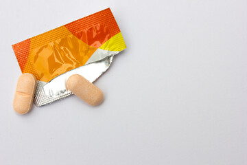 Vitamin C tablets that have just been taken out of their packaging on a white background. Studies have shown that vitamin C may help lower blood pressure.