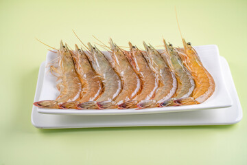 Fresh shrimps neatly arranged on a white tray