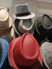 various kinds of cowboy hats in red and black colors sold in the market