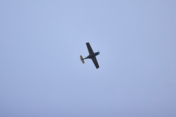 a recreational plane seen from below in the sky