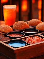 Wooden tray with assorted burger ingredients and a drink