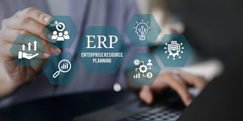A young person using laptop with ERP Enterprise Resource Planning System Concept on visual screen.