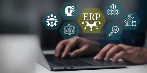 A young person using laptop with ERP Enterprise Resource Planning System Concept on visual screen.