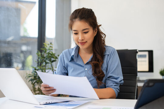 Business woman or financial data analysts working with alculator and laptop computers and data graphs together. Plan to analyzing projects in the office.