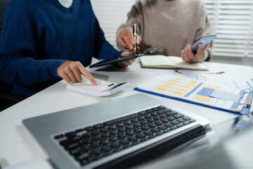 Business consultants discuss tax, merger strategy and restructuring in modern office.