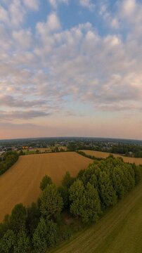 Aerial view of fields in summer evening sunset with beautiful clouds - Equirectangular 360 degree loop video