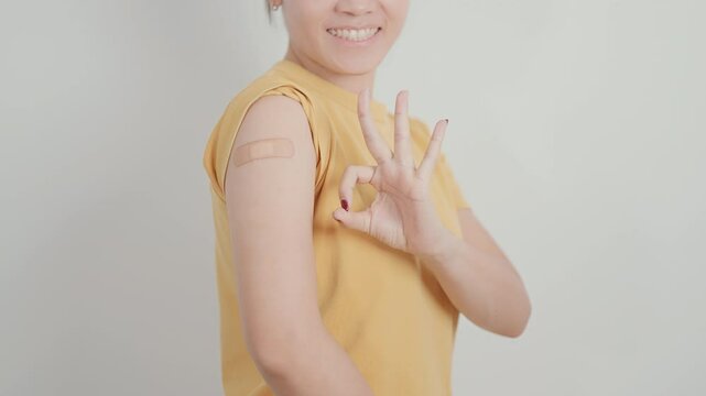 Adult Woman with bandage after received vaccine. Vaccination and Immunization for Influenza, HPV, Zoster, IPD, DTP or Diphtheria, Tetanus and Pertussis, MMR, Hepatitis B, Covid and Varicella vaccine