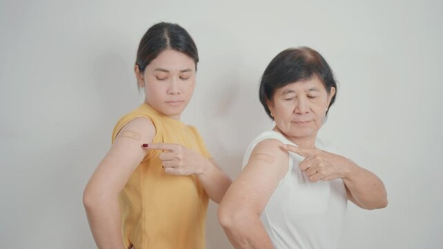 Adult and Elderly Woman with bandage after received vaccine. Vaccination and Immunization for Influenza, HPV, Zoster, IPD, DTP, Dengue, Encephalitis, Rabies, Pneumococcal Hepatitis B and Covid vaccine