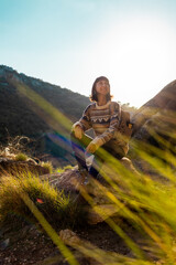 happy woman with backpack in mountains. girl smiles. trekking and hiking. Concept of sport and healthy lifestyle.