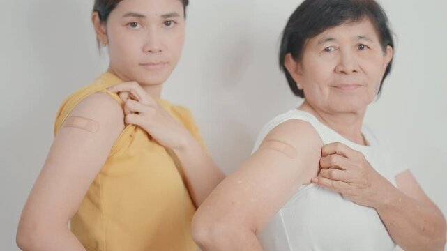 Adult and Elderly Woman with bandage after received vaccine. Vaccination and Immunization for Influenza, HPV, Zoster, IPD, DTP, Dengue, Encephalitis, Rabies, Pneumococcal Hepatitis B and Covid vaccine