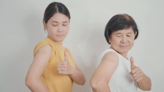 Adult and Elderly Woman with bandage after received vaccine. Vaccination and Immunization for Influenza, HPV, Zoster, IPD, DTP, Dengue, Encephalitis, Rabies, Pneumococcal Hepatitis B and Covid vaccine