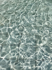Texture of blue water in an old swimming pool.