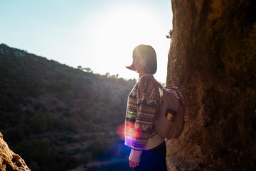 happy woman with backpack in mountains. girl smiles. trekking and hiking. Concept of sport and healthy lifestyle.