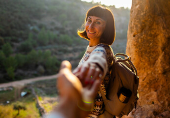 follow me. happy couple traveling. portrait of happy female tourist in mountains. girl smiling. trekking and hiking. girl with backpack.