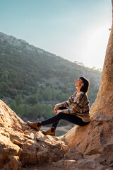 Woman in the mountains. Girl traveling in the mountains. Trekking and hiking. Girl with a backpack.