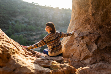 Girl with backpack. Portrait of happy female tourist in mountains. Trekking and hiking.