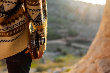 happy woman in the mountains with a camera in her hands enjoying the moment. trekking and hiking. girl with a camera.