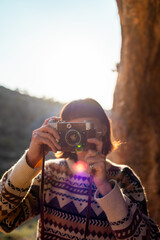 happy woman in the mountains with a camera in her hands enjoying the moment. trekking and hiking. girl with a camera.