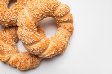 Simit or gevrek, round bagel with sesame seeds on white background top view. Traditional Turkish...