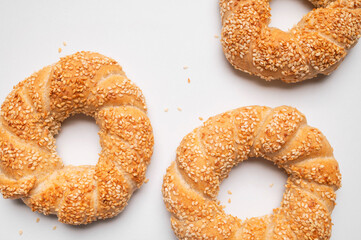 Simit or gevrek, round bagel with sesame seeds on white background top view. Traditional Turkish...
