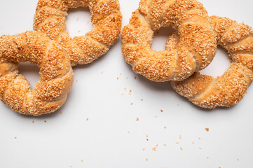 Simit or gevrek, round bagel with sesame seeds on white background top view. Traditional Turkish...
